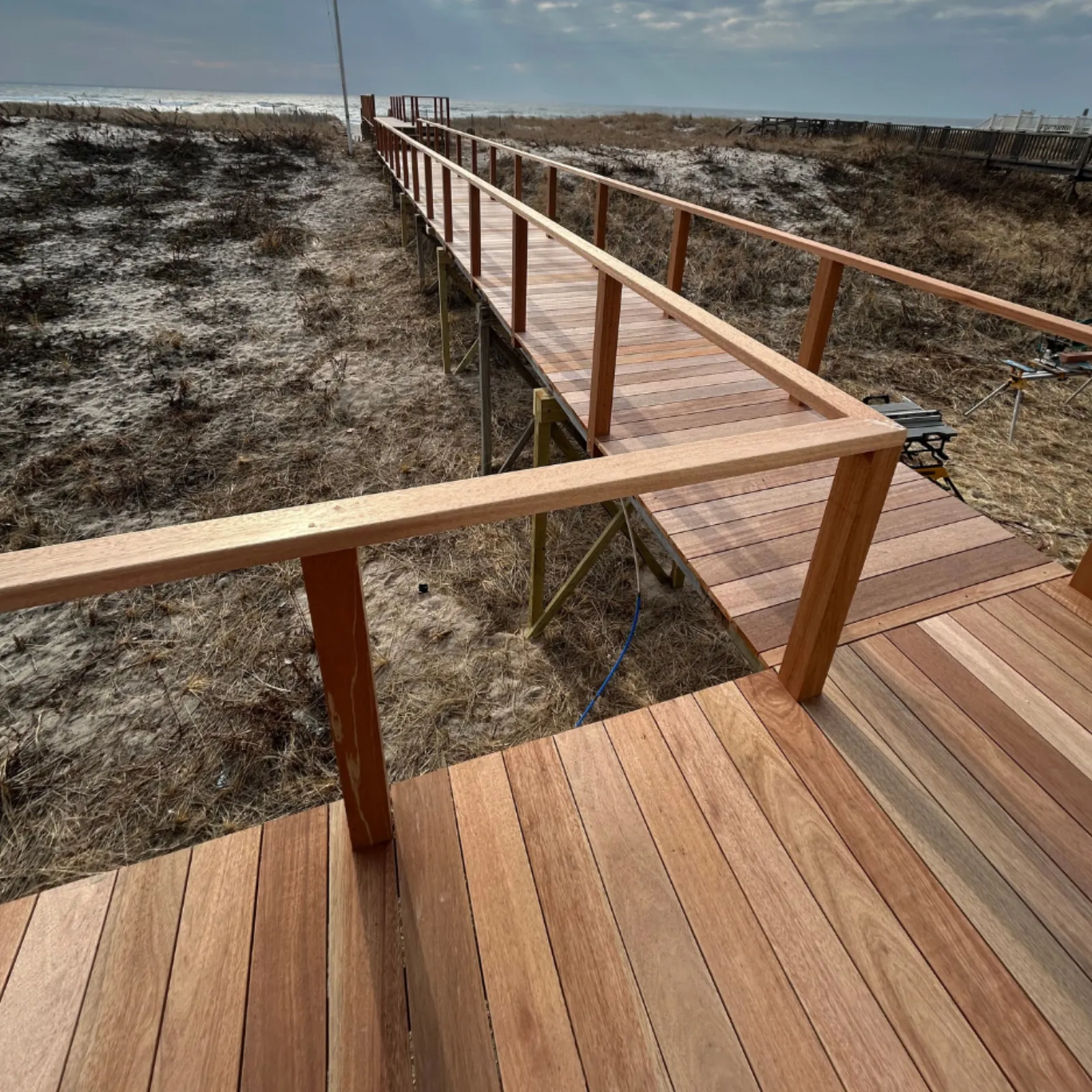 Beach boardwalk to the dunes — rebuilt in mahogany with new railings — after
