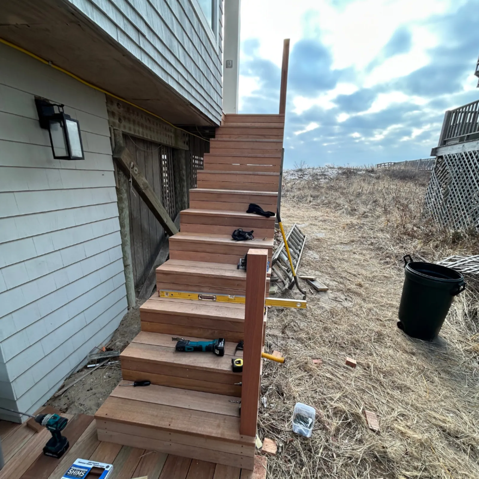 Exterior staircase — full rebuild with new mahogany treads and railings — after